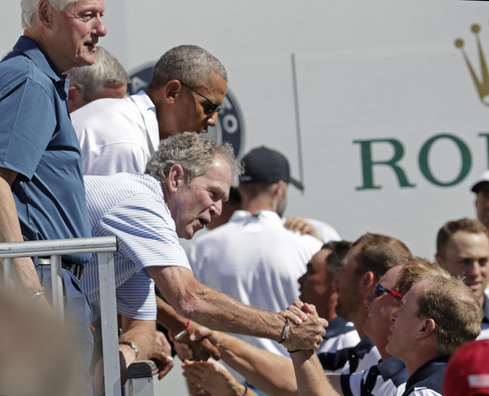 <p>Former Presidents Bill Clinton, George Bush and Barack Obama, greet the U.S. team before the first round of the Presidents Cup at Liberty National Golf Club in Jersey City, N.J., Thursday, Sept. 28, 2017. (AP Photo/Julio Cortez) </p>