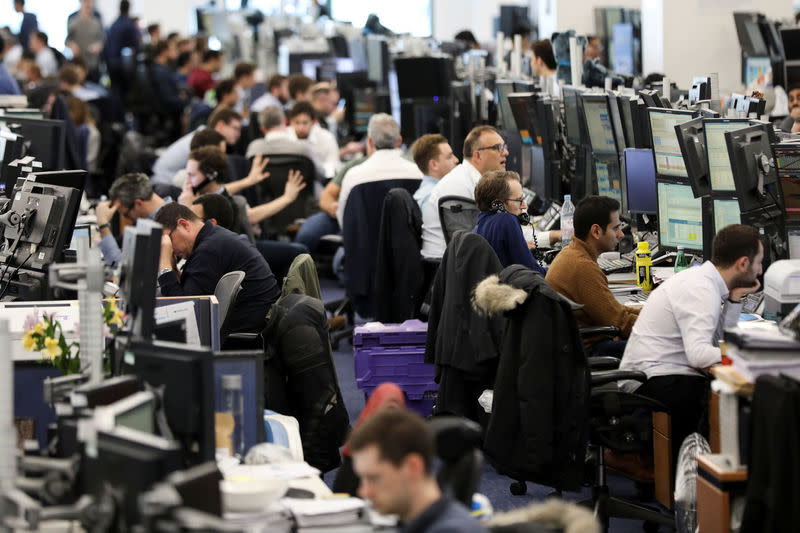 FILE PHOTO: Traders work on the trading floor of Barclays Bank at Canary Wharf in London, Britain December 7, 2018. REUTERS/Simon Dawson