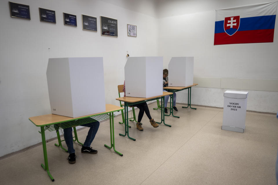 Voters fill their ballots at a polling station in Bratislava, Slovakia, Saturday, Sept. 30, 2023. Slovakia holds an early parliamentary election that pits populist former Prime Minister Robert Fico who campaigned on a clear pro-Russia and anti-American message against a liberal pro-West newcomer. (AP Photo/Darko Bandic)