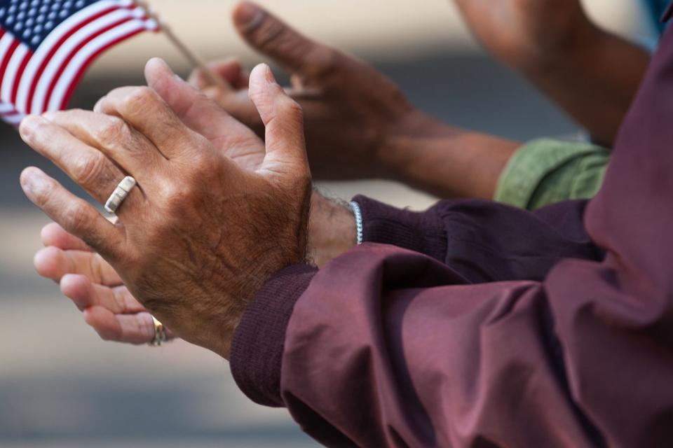 <p>Getty</p> Stock photo of hands clapping with an American flag 