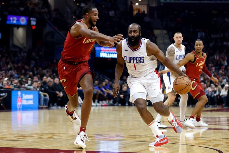 Los Angeles Clippers guard James Harden (1) drives against Cleveland Cavaliers forward Evan Mobley, left, during the first half of an NBA basketball game, Monday, Jan. 29, 2024, in Cleveland. (AP Photo/Ron Schwane)