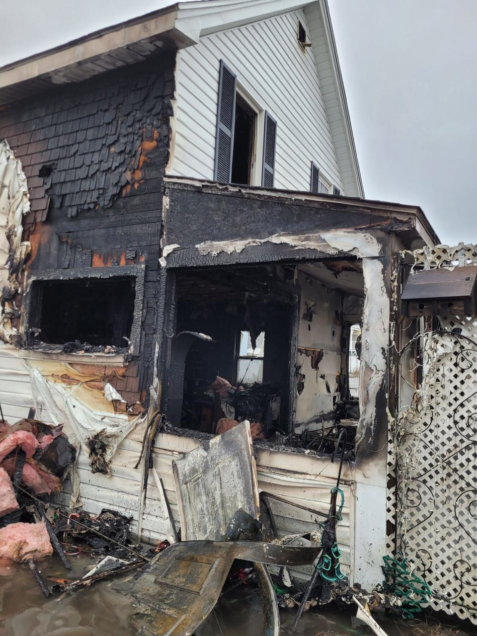 A fire destroyed a home at 16-1/2 I St. at Hampton Beach Friday, Dec. 23, 2022 during a storm surge that flooded roads.