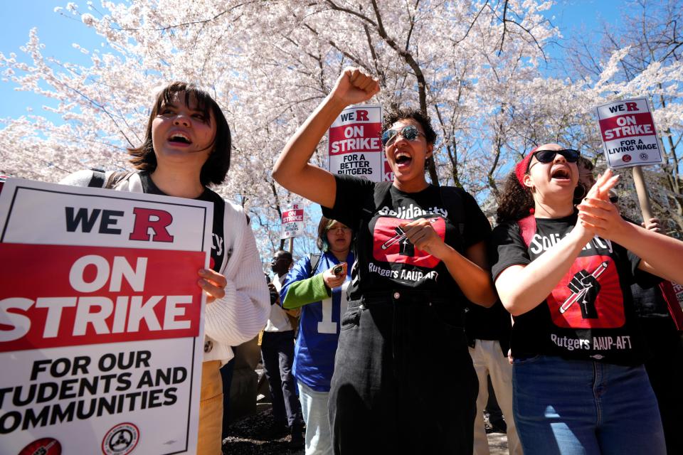 Graduate students, Eleanor Lenoe, of Rochester, NY along with Sarah Coffman and A.J. Boyd, both of Highland Park, are shown during the rally at Rutgers University, in New Brunswick. Monday, April 10, 2023 