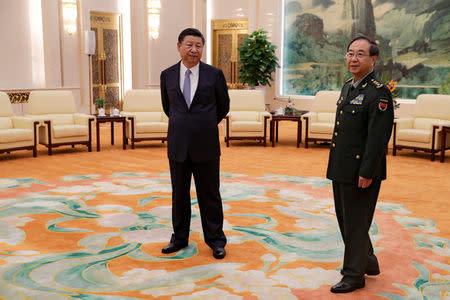 FILE PHOTO: Chinese President Xi Jinping and Gen. Fang Fenghui, chief of the general staff of the Chinese People's Liberation Army, wait to meet with U.S. Chairman of the Joint Chiefs of Staff Gen. Joseph Dunford at the Great Hall of the People in Beijing, China August 17, 2017. REUTERS/Andy Wong/Pool/File Photo