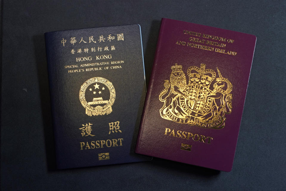 A British National Overseas passports (BNO) and a Hong Kong Special Administrative Region of the People's Republic of China passport are pictured in Hong Kong, Friday, Jan. 29, 2021. China said Friday it will no longer recognize the British National Overseas passport as a valid travel document or form of identification amid a bitter feud with London over a plan to allow millions of Hong Kong residents a route to residency and eventual citizenship. (AP Photo/Kin Cheung)