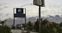 This May 24, 2021, photo shows the sign for the Open Door Baptist Church along a highway leading into Anchorage, Alaska. The church has replaced a strip club that used to beckon people off the highway. (AP Photo/Mark Thiessen)