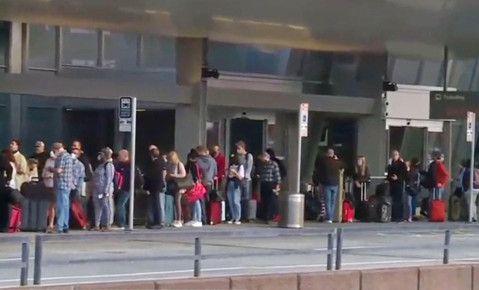 Lines of passengers are seen outside Raleigh-Durham International Airport after a power outage caused major delays Friday.  (via WRAL)