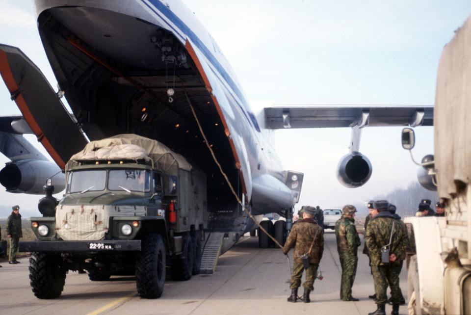 Russian paratroopers unload a truck from an IL-76