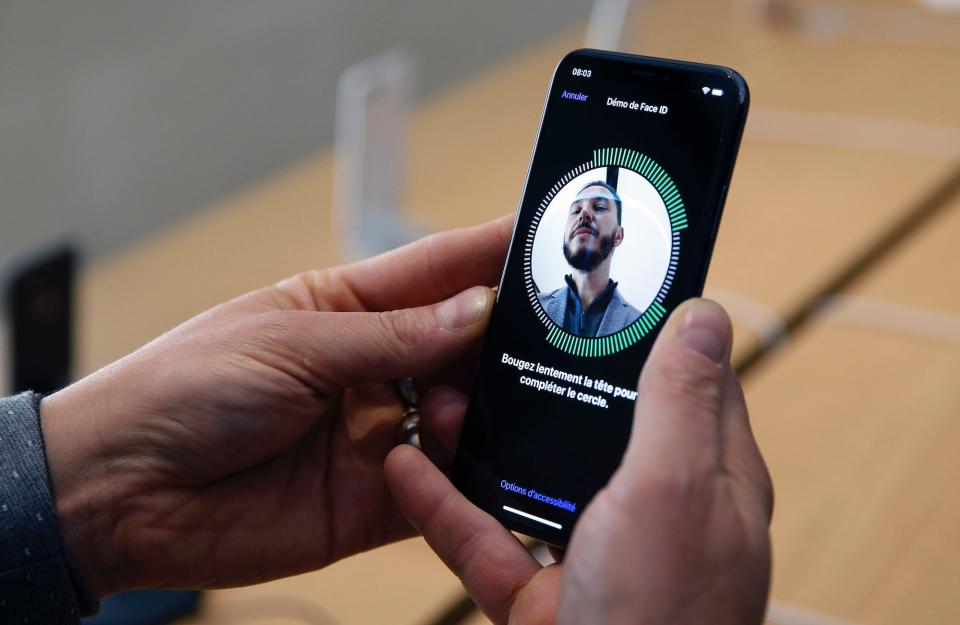 A customer uses the new face-recognition software on the Apple iPhone X, the new model of Apple smartphone at the Apple Store Saint-Germain on November 3, 2017 in Paris, France.