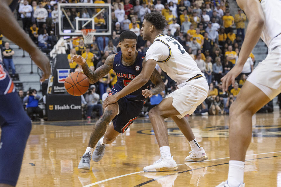 Missouri's Tray Jackson, right, knocks the ball away from Auburn's J'Von McCormick during the first half of an NCAA college basketball game Saturday, Feb. 15, 2020, in Columbia, Mo. Missouri won 85-73. (AP Photo/L.G. Patterson)