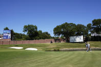 Coilin Morikawa walks up the 16th fairway with his caddie during the final round of the Charles Schwab Challenge golf tournament at the Colonial Country Club in Fort Worth, Texas, Sunday, June 14, 2020. (AP Photo/David J. Phillip)