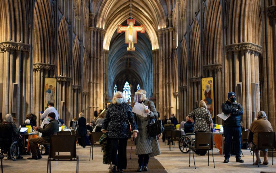 Audrey Elson, 84, leaves with her daughter after receiving an injection of the Oxford/AstraZeneca coronavirus vaccine at Lichfield Cathedral, Staffordshire. - Jacob King/PA