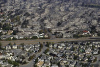 <p>Homes destroyed from fires are seen from an aerial view in Santa Rosa, Calif., Wednesday, Oct. 11, 2017. (Photo: Jeff Chiu/AP) </p>