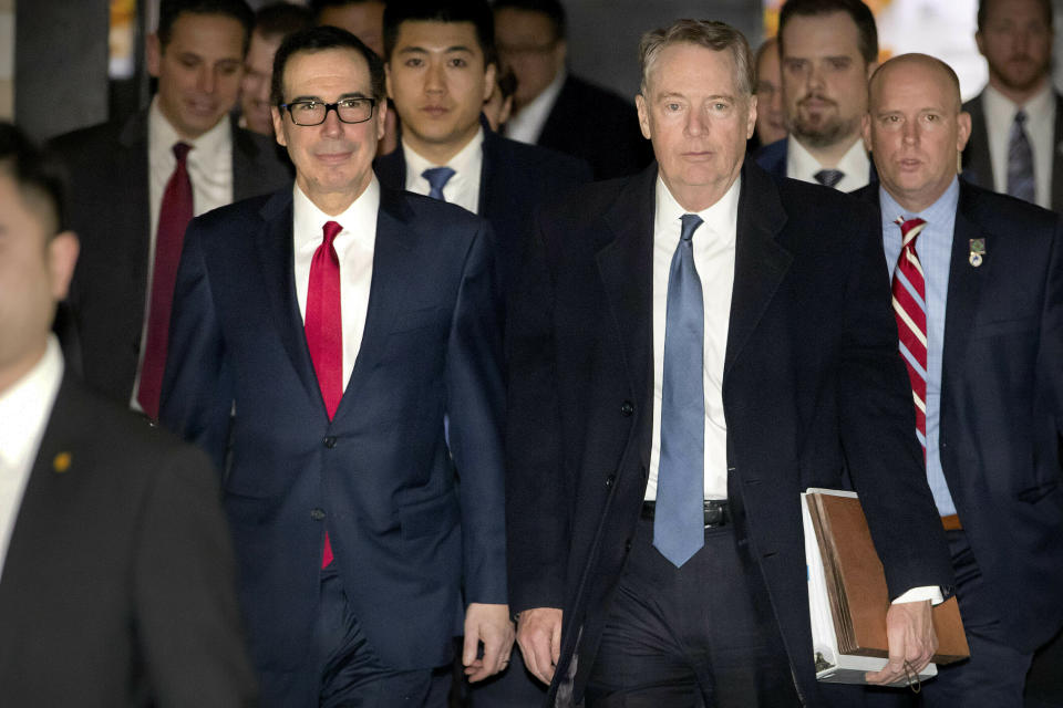 FILE - In this Feb. 15, 2019, file photo, U.S. Treasury Secretary Steven Mnuchin, left, and U.S. Trade Representative Robert Lighthizer walk together as they leave their hotel in Beijing. China says U.S. trade negotiators will arrive in Beijing late Thursday afternoon and start the new round talks with a working dinner. (AP Photo/Mark Schiefelbein, File)