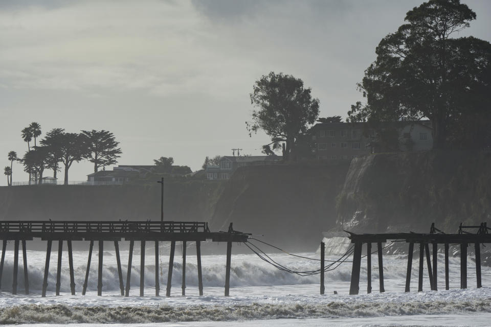 The Capitola Wharf is seen damaged from storm waves in Capitola, Calif., Thursday, Jan. 5, 2023. Damaging hurricane-force winds, surging surf and heavy rains from a powerful “atmospheric river” pounded California on Thursday, knocking out power to tens of thousands, causing flooding, and contributing to the deaths of at least two people, including a child whose home was hit by a falling tree. (AP Photo/Nic Coury)