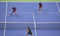 Juan Sebastian Cabal, top left, of Colombia returns a shot to Horacio Zeballos and Marcel Granollers, of Spain, as doubles partner Robert Farah, of Colombia, looks on during the doubles final of the U.S. Open tennis championships Friday, Sept. 6, 2019, in New York. (AP Photo/Sarah Stier)