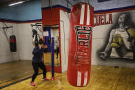 Cristina Pastor, wearing face masks to prevent the spread of the coronavirus, exercises at a boxing gym in the southern neighbourhood of Vallecas in Madrid, Spain, Monday, Sept. 28, 2020. (AP Photo/Bernat Armangue)