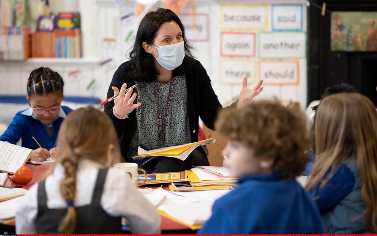  A teacher holds a creative writing class at Roath Park Primary School while wearing a face mask in Cardiff, Wales - Getty