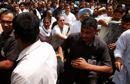 India’s main opposition Congress party president Sonia Gandhi pushes security member to make way for herself as she takes part in what the party calls as a "Save Democracy" march to parliament in New Delhi, India, May 6, 2016. REUTERS/Adnan Abidi