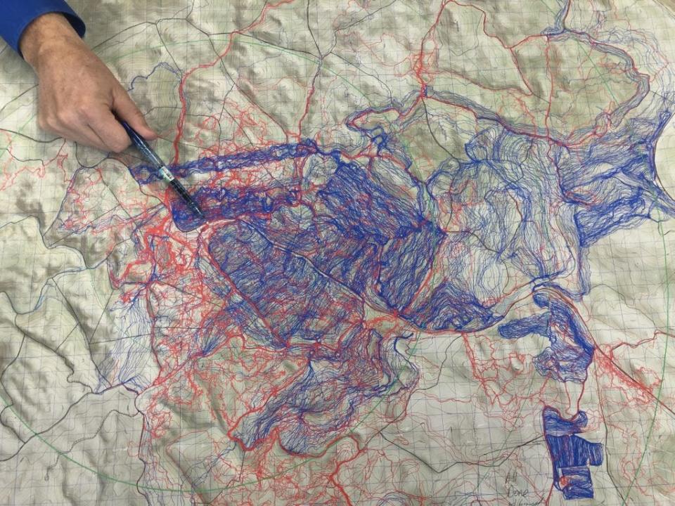 This file photo of a map shows lines where people and dogs searched for Serenity Dennard in the area around the Black Hills Children’s Home south of Rockerville. The lines, recorded by GPS devices, are blue in places where people have searched and red in spots where people and dogs have searched together. The hand of Pennington County then-Sheriff Kevin Thom is pointing to where Serenity Dennard was last seen, about 50 yards north of the entrance to the children’s home.