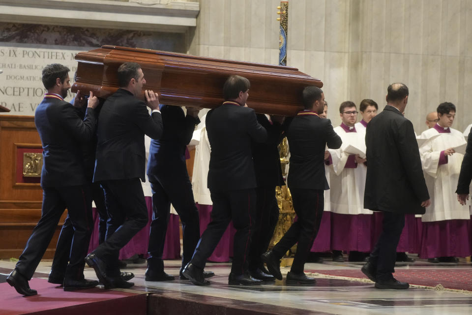 The coffin of Australian Cardinal George Pell is carried in St. Peter's Basilica before the funeral ceremony at the Vatican, Saturday Jan. 14, 2023. Cardinal Pell died on Tuesday at a Rome hospital of heart complications following hip surgery. He was 81. (AP Photo/Gregorio Borgia)