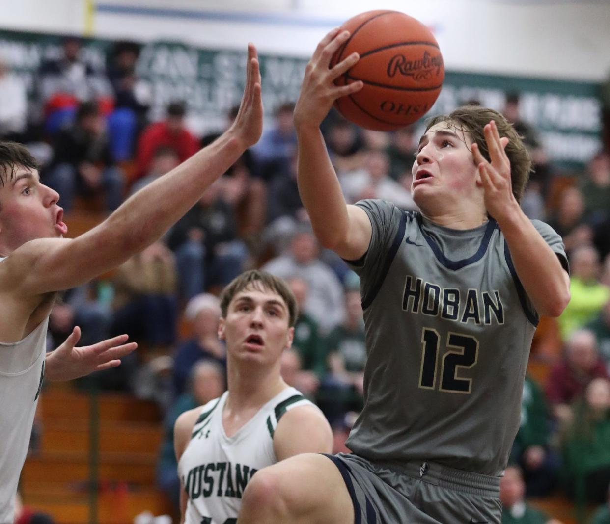 Archbishop Hoban's James McCarthy, right, goes to the basket against a Strongsville defender in a Division I district semifinal Thursday in Elyria. McCarthy hit the game-winning basket Saturday to lift the Knights over Brecksville in a district final.