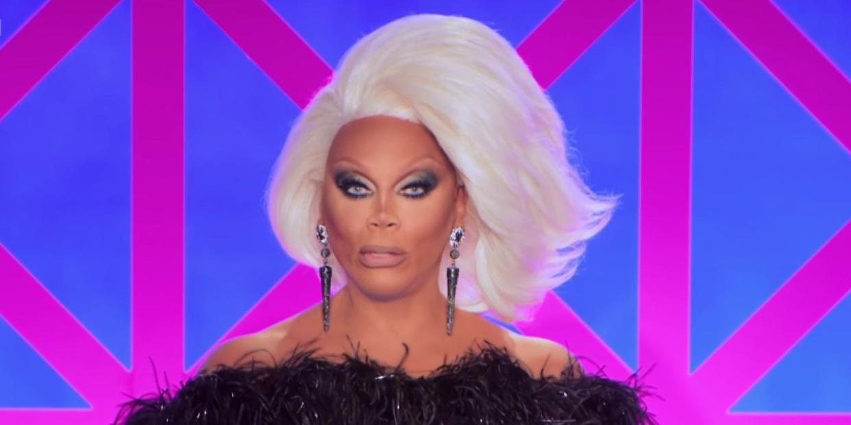 rupaul in drag race uk s5 episode 5, with a short white wig and a black outfit