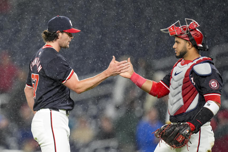 Washington Nationals relief pitcher Kyle Finnegan, left, celebrates with catcher Keibert Ruiz after the team's 5-3 win in a baseball game against the Pittsburgh Pirates at Nationals Park, Wednesday, April 3, 2024, in Washington. (AP Photo/Alex Brandon)