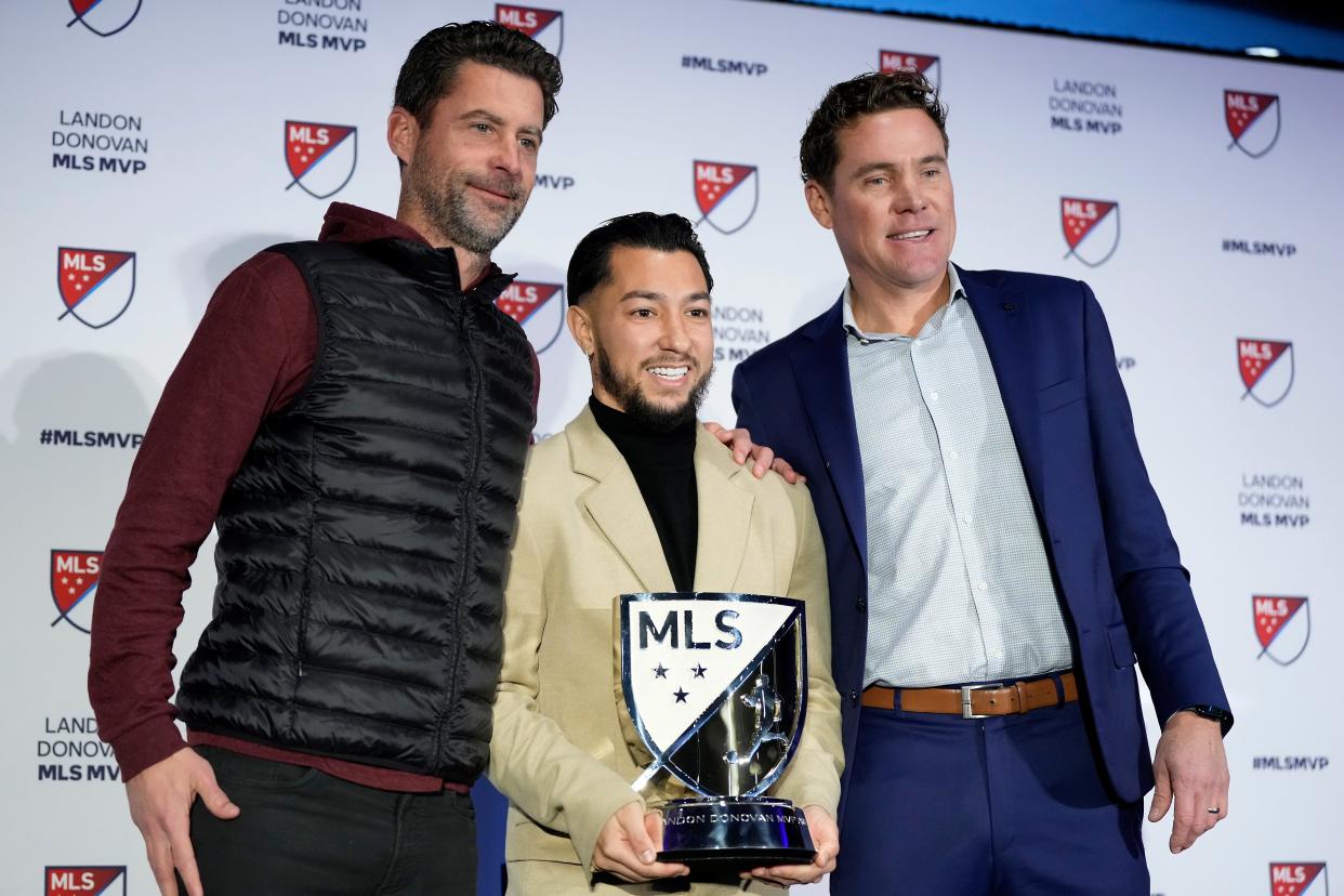FC Cincinnati midfielder Luciano Acosta, center, poses for a photo with team manager Pat Noonan, left, and general manager Chris Albright, right, after being named Major League Soccer’s Most Valuable Player for the 2023 season, Monday, Nov. 27, 2023, at TQL Stadium in Cincinnati.