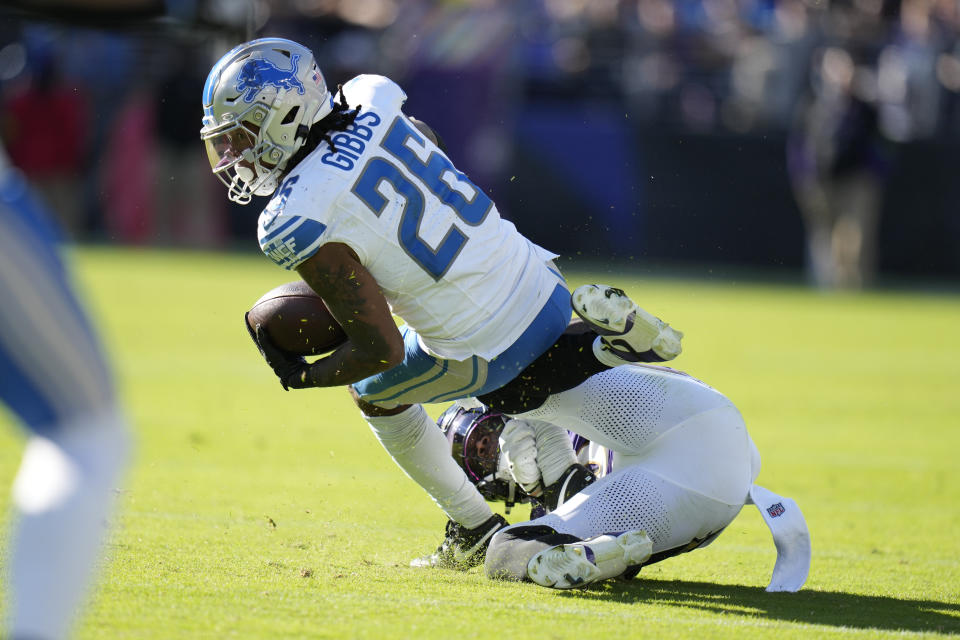 Detroit Lions running back Jahmyr Gibbs (26) is tackled by Baltimore Ravens linebacker Patrick Queen during the second half of an NFL football game, Sunday, Oct. 22, 2023, in Baltimore. (AP Photo/Alex Brandon)