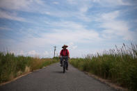 <p>Local resident Wayne Crokett, 72, rides along Factory Road on Tangier Island, Virginia, Aug. 2, 2017. (Photo: Adrees Latif/Reuters) </p>