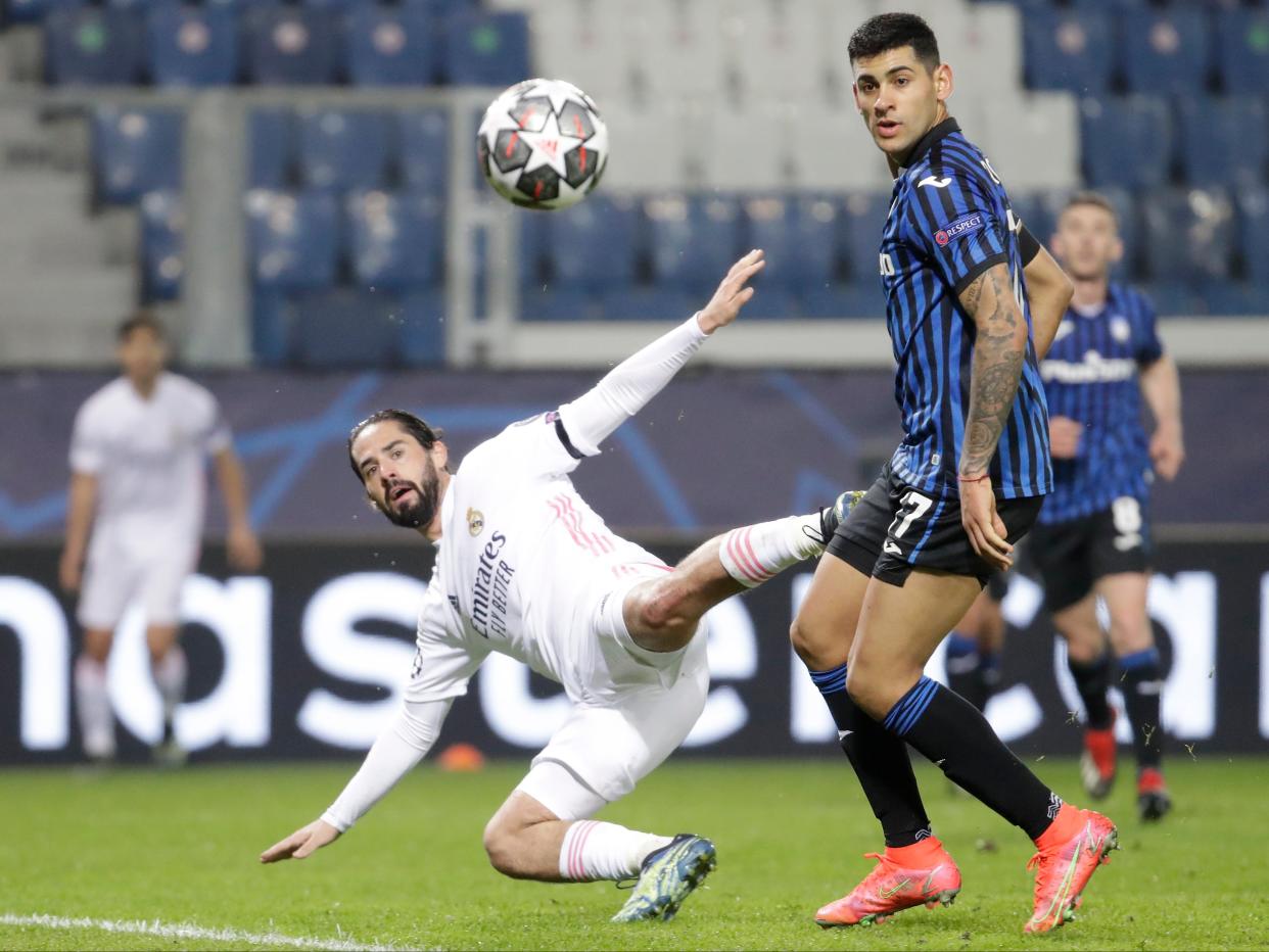 <p>Isco fights for the ball with Cristian Romero</p> (AP)