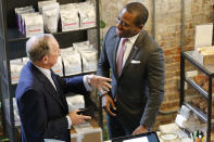 Democratic presidential candidate, former New York Mayor Michael Bloomberg, left, chats with Richmond mayor Levar Stoney at a coffee shop in Richmond, Va., Tuesday, Jan. 7, 2020. (AP Photo/Steve Helber)