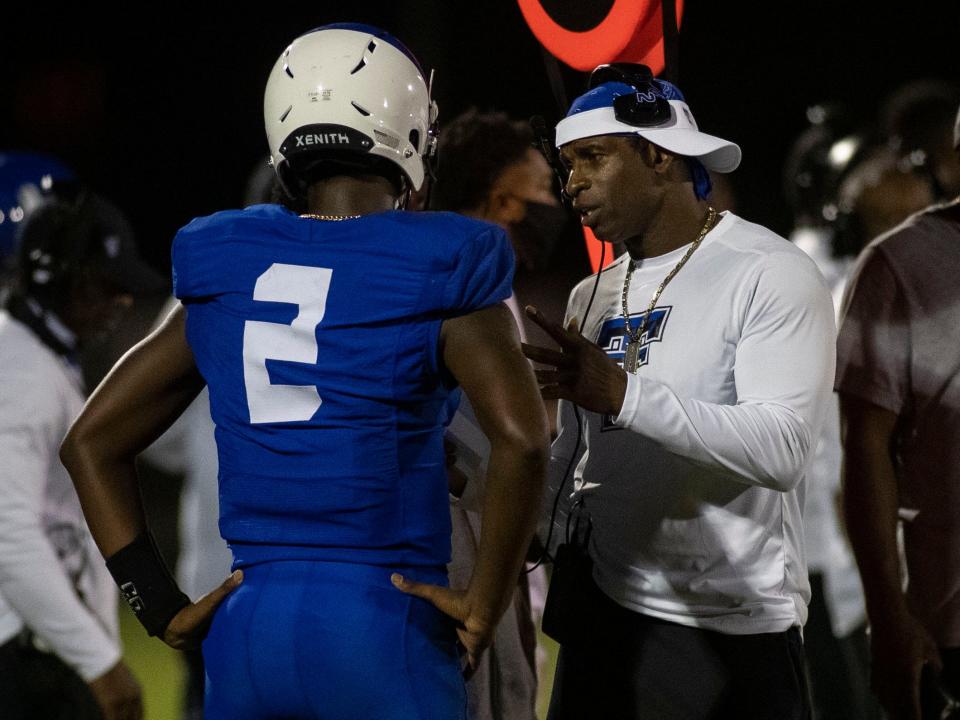 Trinity Christian School quarterback Shedeur Sanders talks with his father, Deion Sanders during a game versus Gadsden County on Friday, Oct. 9, 2020. Father and son are now at Jackson State as head coach and QB.