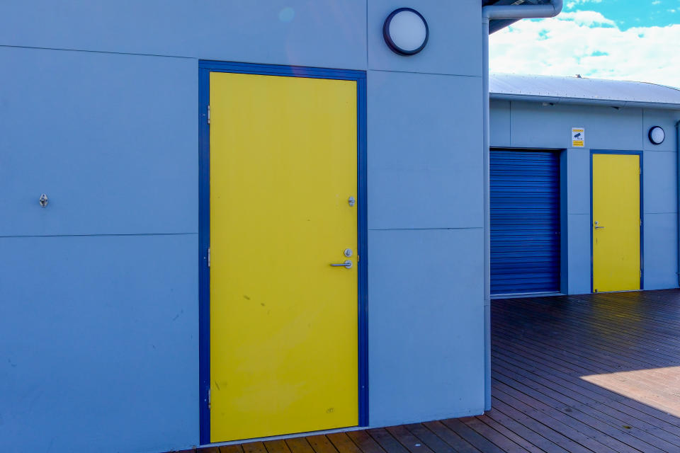 A photo of Yellow doors on blue walls