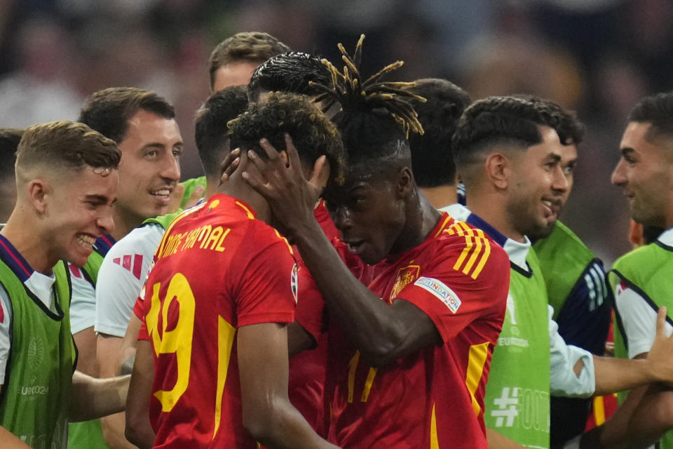 Spain's Lamine Yamal celebrates with his teammate after scoring his side's first goal during a semifinal match between Spain and France at the Euro 2024 soccer tournament in Munich, Germany, Tuesday, July 9, 2024. (AP Photo/Manu Fernandez)