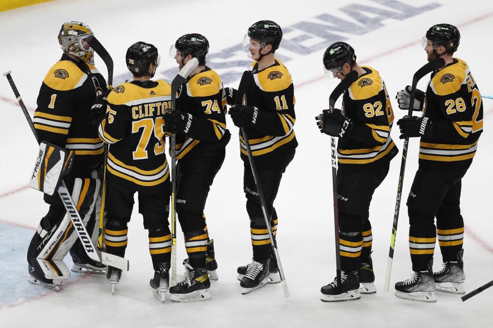 Boston Bruins goalie Jeremy Swayman (1) celebrates with teammates after a win over the Carolina Hurricanes in Game 6 of an NHL hockey Stanley Cup first-round playoff series Thursday, May 12, 2022, in Boston. (AP Photo/Michael Dwyer)