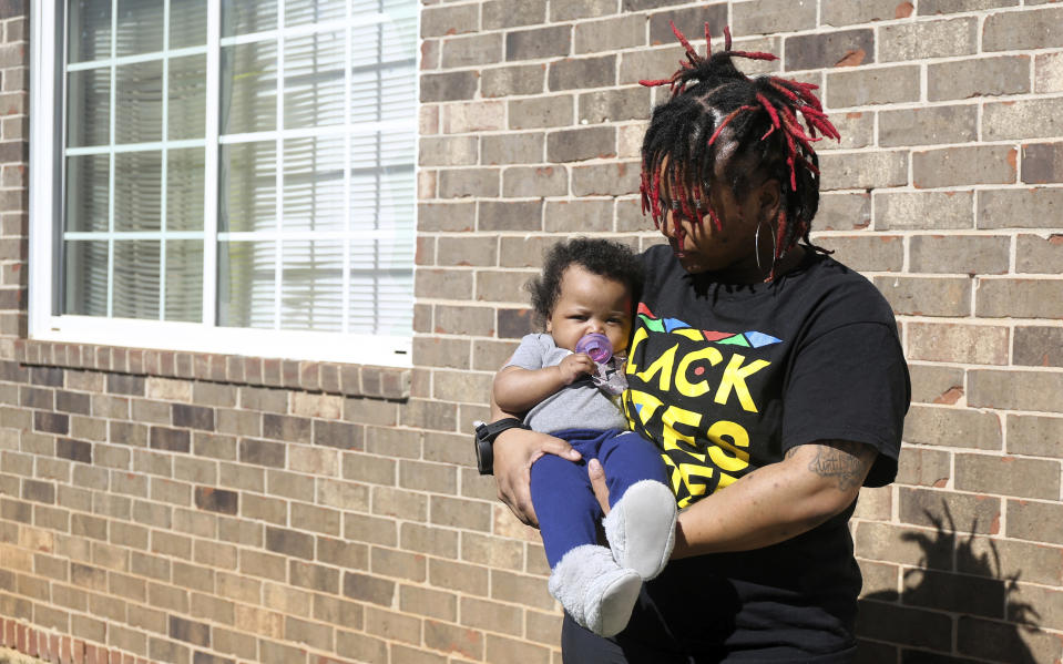 Nia Thomas holds her 4-month-old daughter, Nilah, in front of their Atlanta home on Feb. 14, 2024. Thomas was bailed out of jail by the nonprofit Barred Business in 2022 through the “Mama’s Day Bail Out,” initiative, a practice that could be significantly restricted, if not criminalized, under a recently passed Georgia bill. (AP Photo/R.J. Rico)