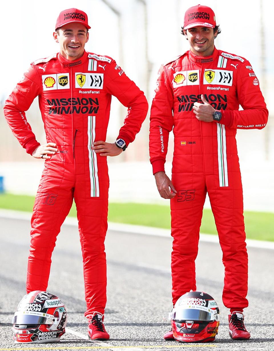 Charles Leclerc of Monaco and Ferrari and team mate Carlos Sainz of Spain and Ferrari speak with Sebastian Vettel of Germany and Aston Martin F1 on the grid during Day One of F1 Testing at Bahrain International Circuit on March 12, 2021 in Bahrain, Bahrain.