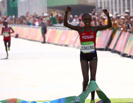 FILE PHOTO: 2016 Rio Olympics - Athletics - Final - Women's Marathon - Rio de Janeiro, Brazil - 14/08/2016. Jemima Sumgong of Kenya celebrates as she crosses the finish line to win the race REUTERS/David Gray