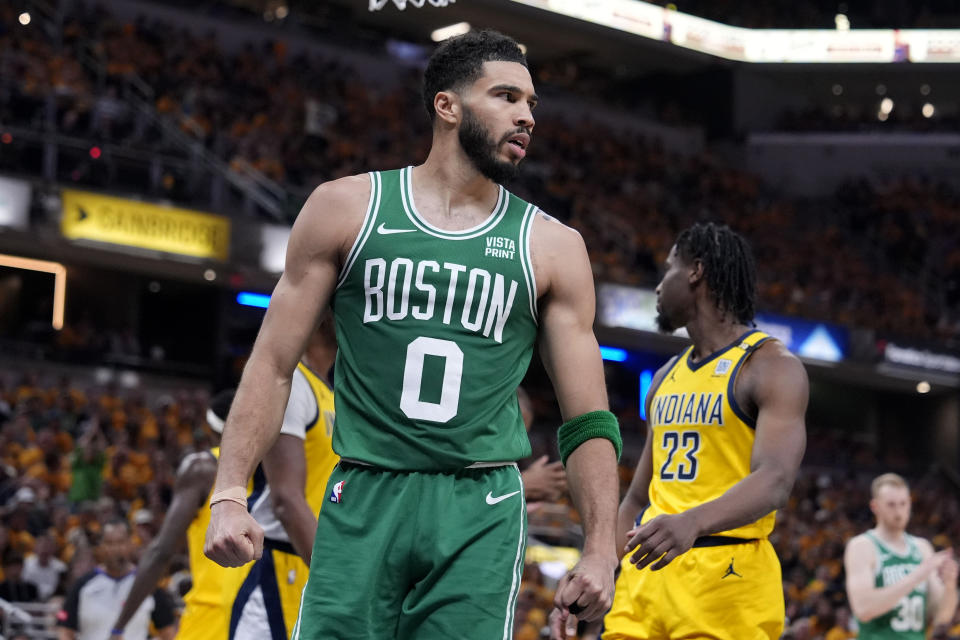 Boston Celtics forward Jayson Tatum (0) reacts after making a basket during the first half of Game 4 of the NBA Eastern Conference basketball finals against the Indiana Pacers, Monday, May 27, 2024, in Indianapolis. (AP Photo/Michael Conroy)