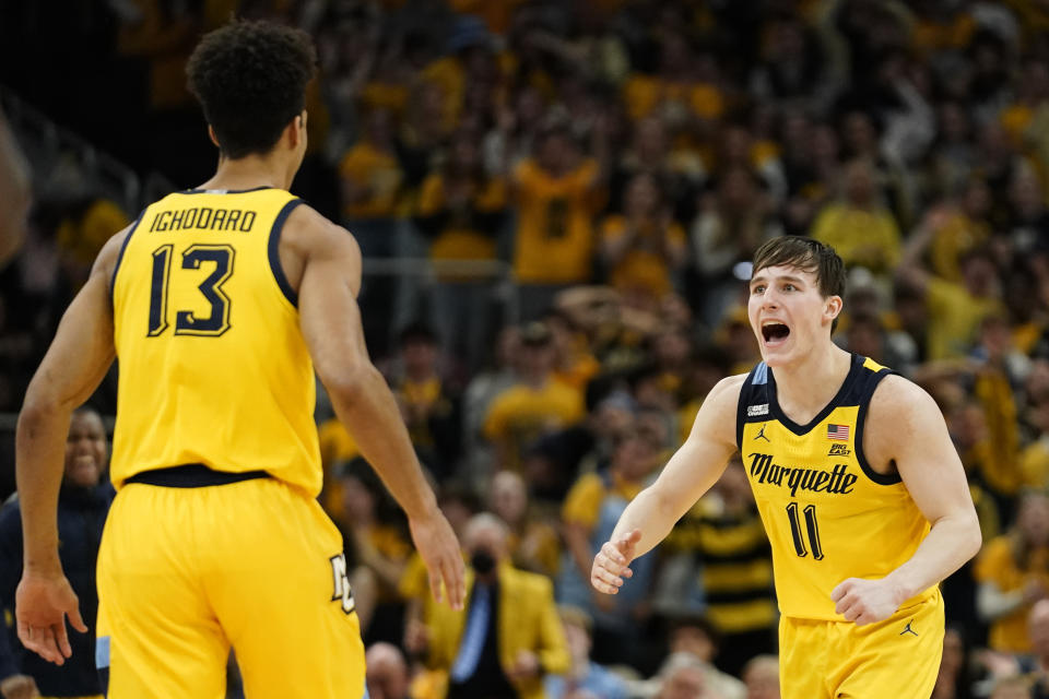 Marquette's Tyler Kolek (11) reacts with Oso Ighodaro (13) during the first half of the team's NCAA college basketball game against DePaul on Saturday, Feb. 25, 2023, in Milwaukee. (AP Photo/Aaron Gash)