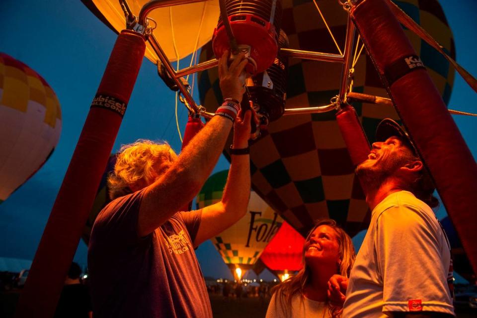 Maui McCraney, right, and Amy Culmoney, of Orange Beach, Alabama, sit inside a hot airballon basket during the Gulf Coast Hot Air Balloon Festival at OWA in Foley, Alabama on Thursday, May 4, 2023.