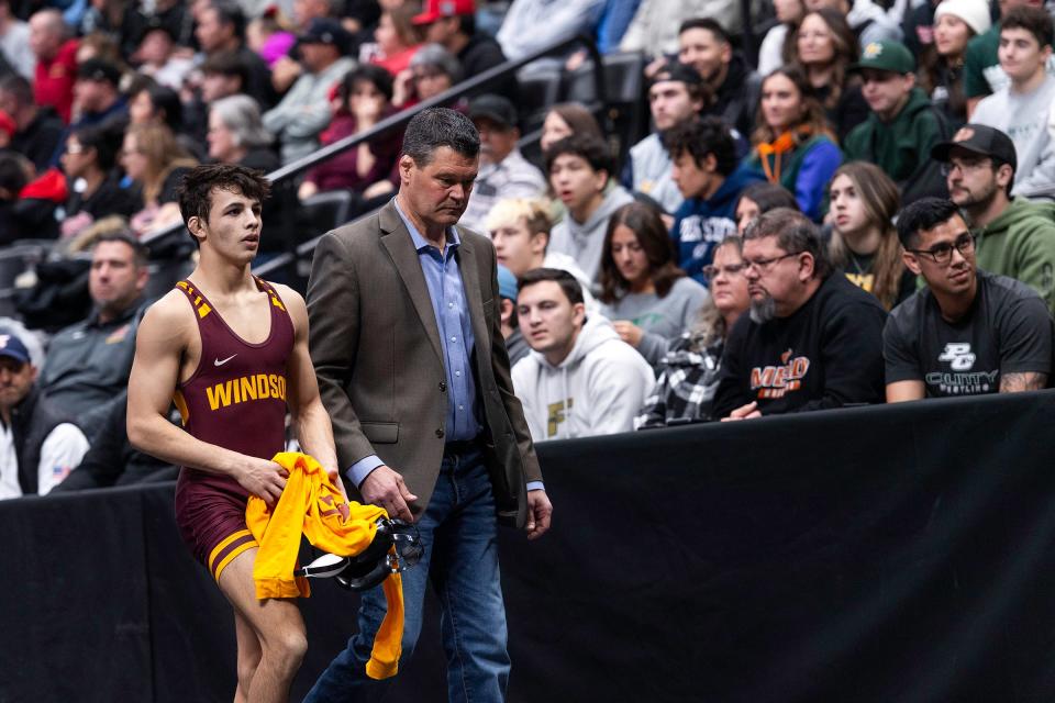 Windsor's James Pantoja and wrestling coach Monte Trusty walk off the mat after losing his finals match at the Colorado state wrestling tournament at Ball Arena in Denver on Saturday.