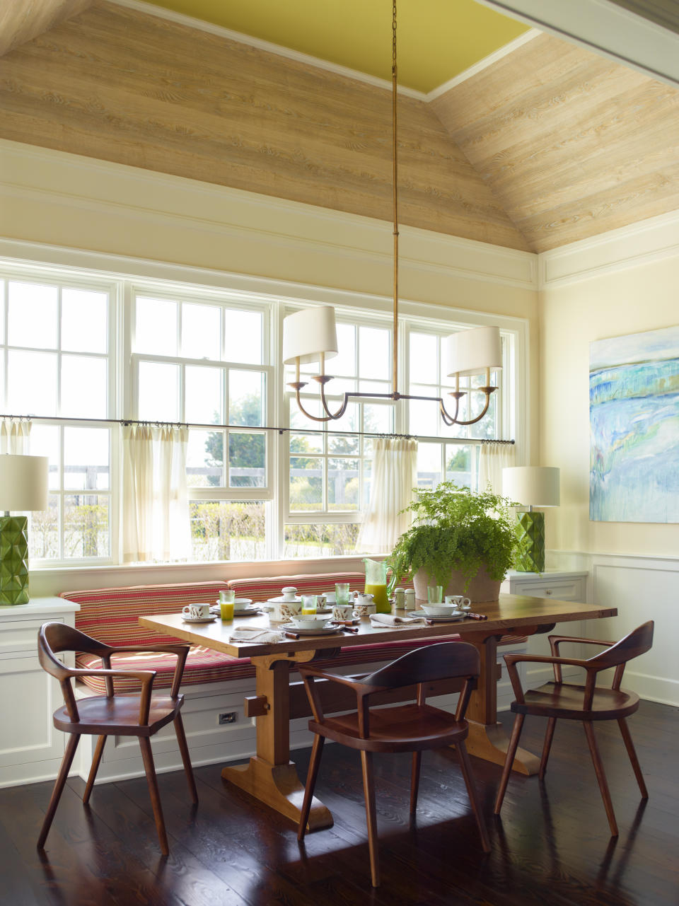 This undated photo shows a kitchen designed by Gideon Mendelson in a Hamptons retreat in New York. In the home, Mendelson's team used faux wood wallcovering from French firm Nobilis to add a beachy feel to the ceiling, punctuated with fresh Lilly Pulitzer-esque green paint. (Eric Piasecki/Gideon Mendelson/Mendelson Group via AP)