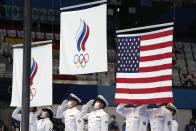 Flags are raised for the ceremony for the men's 100m backstroke swimming final at the 2020 Summer Olympics, Tuesday, July 27, 2021, in Tokyo, Japan. (AP Photo/Martin Meissner)