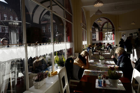 People spend time at Cafe Byfyj in Nikiszowiec district in Katowice, Poland, October 24, 2018. REUTERS/Kacper Pempel