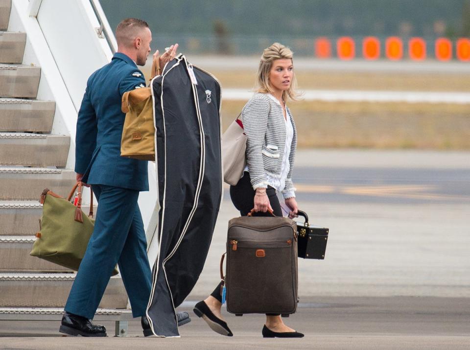 Natasha carrying the Princess’ bags from a plan in Canada during her 2016 royal tour (Getty)