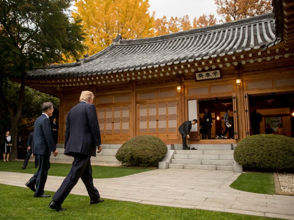 Former US President Donald Trump and former South Korean President Moon Jae-in walk through the gardens together at the Blue House in Seoul, South Korea, Tuesday, November 7, 2017.