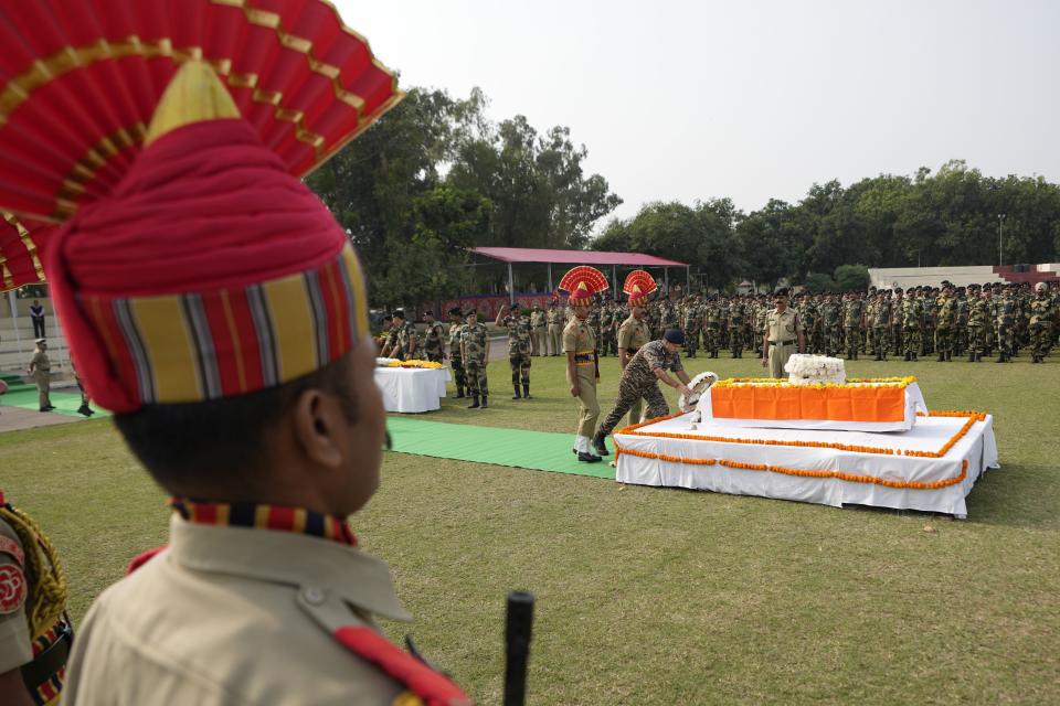 Indian Border Security Force (BSF) soldiers pay tribute to their colleague Lal Fam Kima during a wreath-laying ceremony at the BSF headquarters in Jammu, India, Thursday, Nov.9, 2023. The BSF soldier was killed as Indian and Pakistani soldiers exchanged gunfire and shelling along their highly militarized frontier in disputed Kashmir. (AP Photo/Channi Anand)